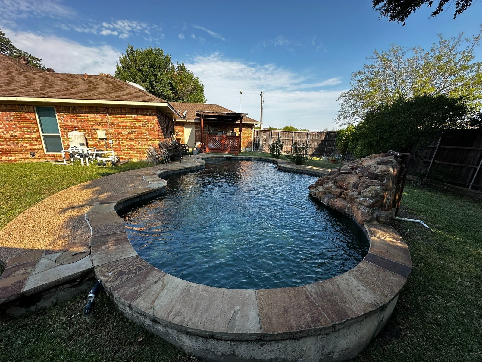 Pool with stone coping and grotto