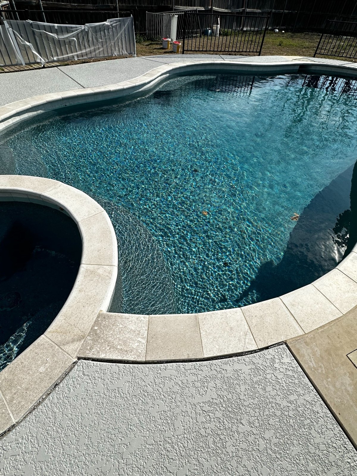 Pool and spa with resurfaced deck